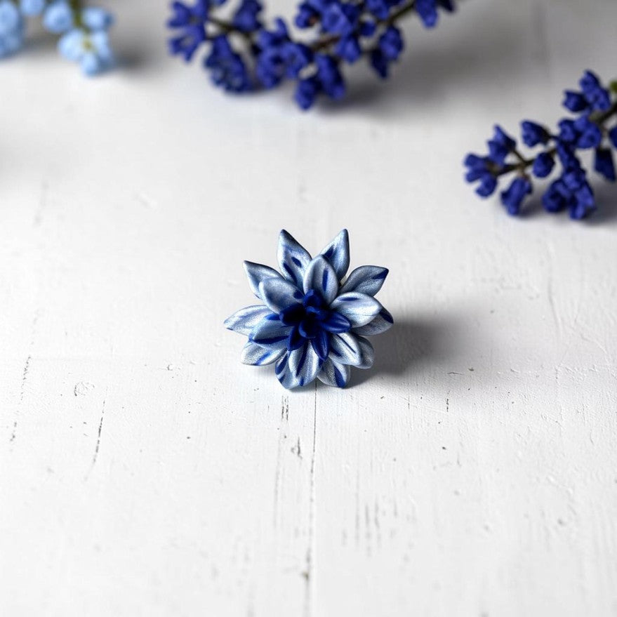 Vista frontal anillo flor en azul claro y azul oscuro, de arcilla polimérica hecho a mano